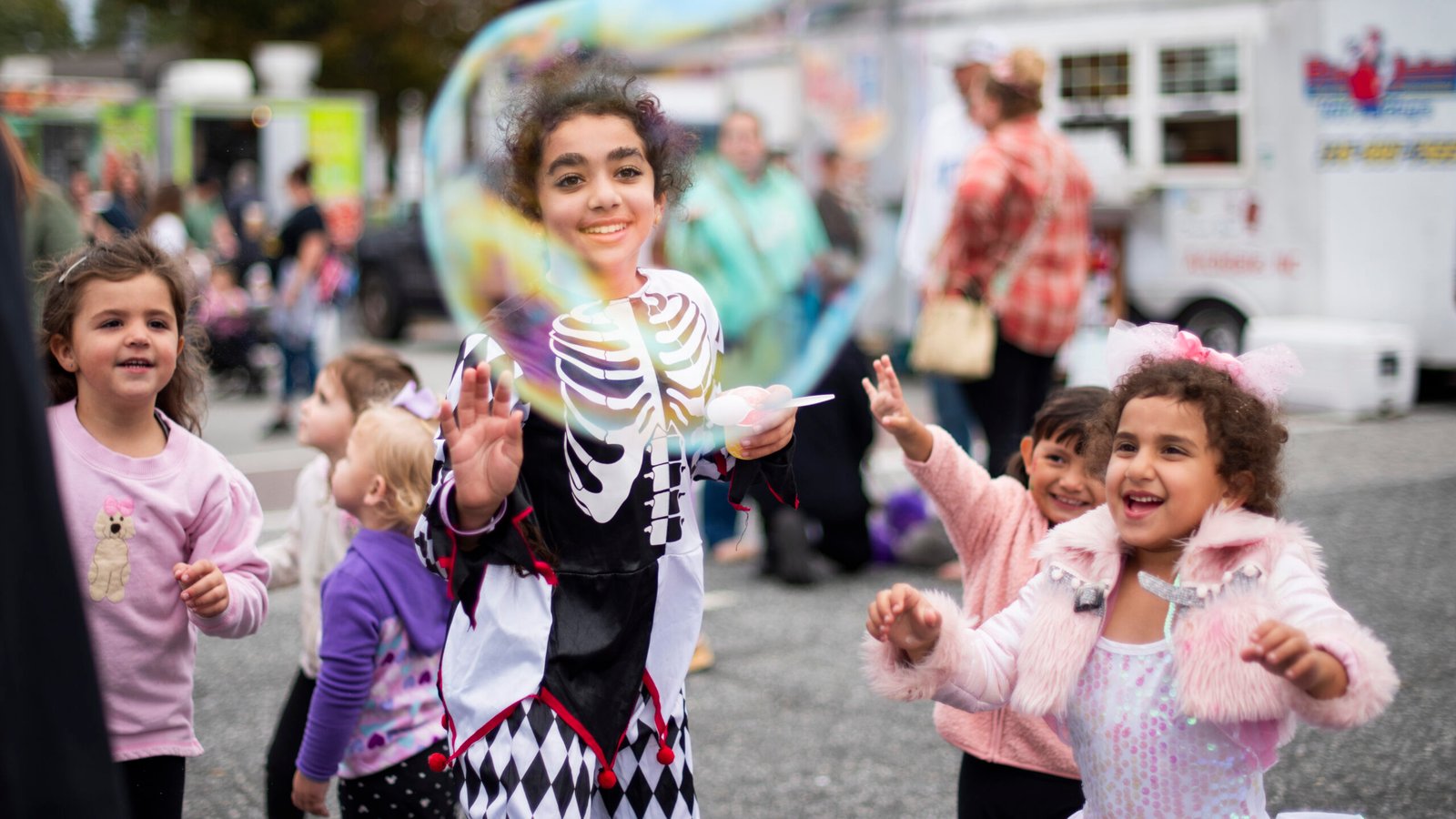 Jennifer Gergis (center) is joined by her sister, Justina (right), as they pop bubbles together at the Bush Hill Festival in Archdale, NC on Saturday, Oct. 11, 2025. (Photo by Sollyn Lindsay).